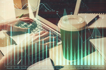 Double exposure of woman hands typing on computer and forex chart hologram drawing. Stock market invest concept.