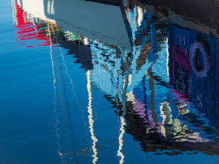 Fototapeta na wymiar Reflections of boat and floating home at Fisherman's Wharf of Victoria, BC