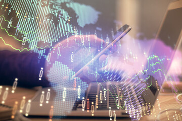 Double exposure of man's hands holding and using a phone and financial graph drawing. Analysis...