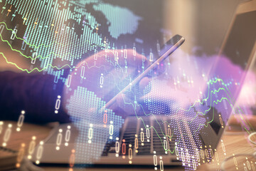 Double exposure of man's hands holding and using a phone and financial graph drawing. Analysis concept.
