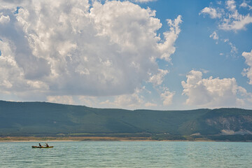 Obraz na płótnie Canvas double kayak on a blue lake