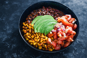 plant-based food,  vegan mexican style nourish bowl with spicy bean chilli avodaco corn and pico de gallo
