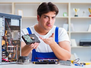 Computer repairman repairing desktop computer