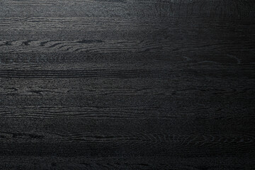 艶のある黒い木製のボードの背景テクスチャー