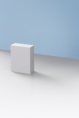 a white box lying on a blue background and white floor.