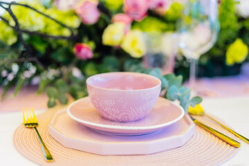 Close up of pink kitchenware for brunch with golden cutlery