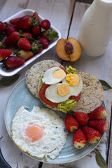 Breakfast with arepa and fruits such as strawberries, peaches and avocados, as well as eggs