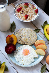 healthy breakfast with egg, arepa, peach and cereals.