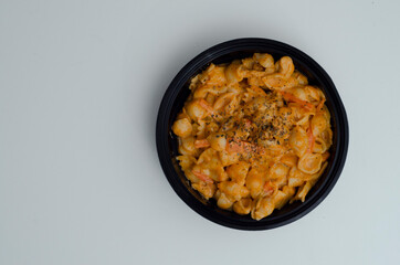 delicious pasta with cheese in a black bowl