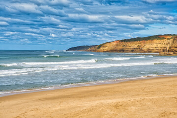 Incoming waves and limestone coastline at Jan Juc beach, Jan Juc, near Torquay, Surf Coast Shire,...