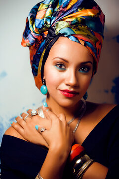 beauty bright african woman with creative make up, shawl on head like cubian closeup smiling