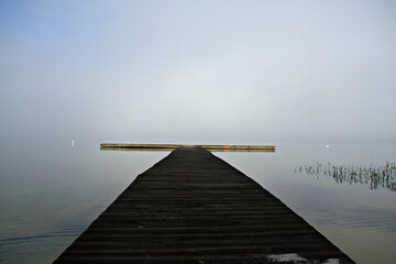 boardwalk to lake in fog