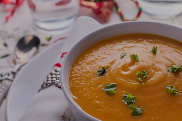 Christmas vegetable soup in a white bowl.