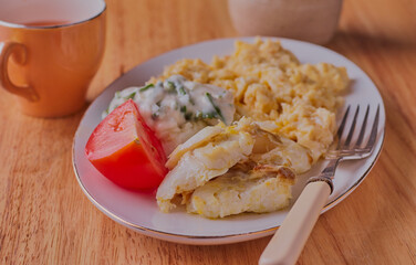 breakfast or fish,eggs and tomato.