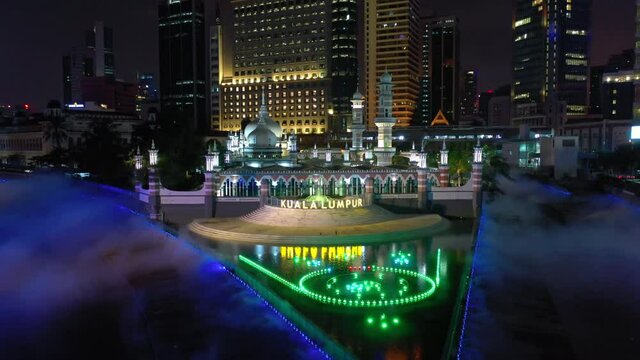 kuala lumpur city downtown famous river of life bay crossing night illumination show aerial panorama 4k malaysia