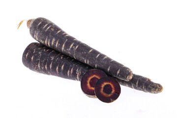 Heap of purple carrots isolated on white background, one cut through