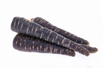 Heap of purple carrots isolated on white background, one cut through