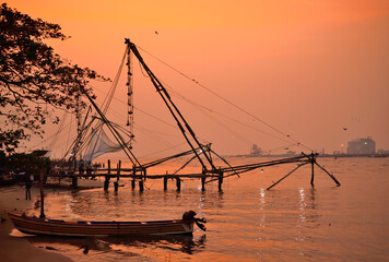 Sunset over chinese fishing net in Kochi backwaters.