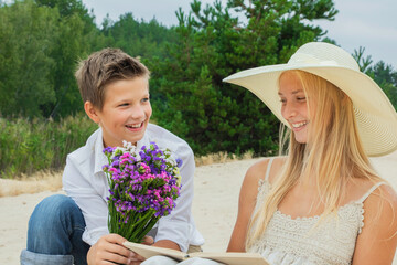 guy and girl with a bouquet of beautiful color in nature in autumn and summer on a date