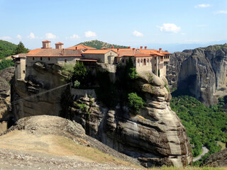 Christian monastery building on the top of hill in Meteora, Greece. Meteora is an UNESCO heritage site for monastery buildings and famous tourist attractions.