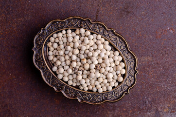 White peppercorn in a metal dish