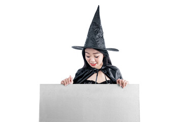 Asian witch woman with hat standing with empty whiteboard