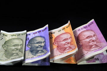 Indian currency. 100, 200, 500, and 2000 rupee note. Indian currency isolated on black background.