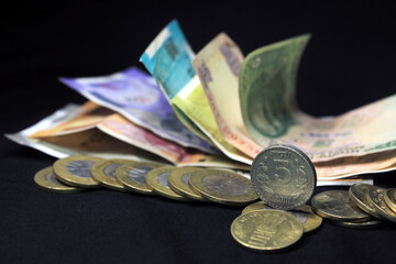 Now and old Indian currencies. 50, 100, 200, 500 rupee notes and coins. Indian currency isolated on black background.