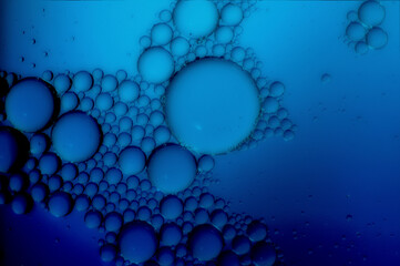 art photo abstract textured background of bubbles of different sizes on blue backdrop