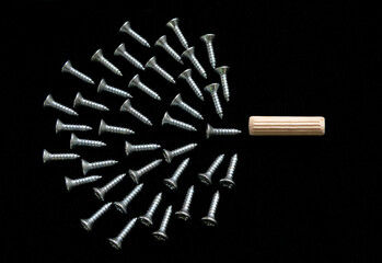 Group of screws pointing to wooden dowel, representation of accurate and original.