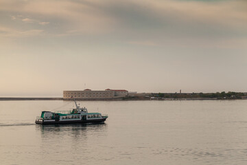 Fototapeta na wymiar Passenger boat goes at Sevastopol bay at evening