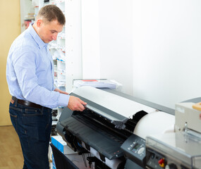 Obraz premium Portrait of male worker at plotter. High quality photo