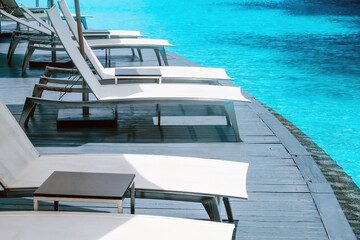 Fototapeta premium Many white chaise lounge by the pool