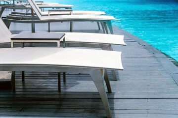 Obraz premium Many white chaise lounge by the pool
