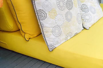 Close up of yellow fabric sofa and cushions
