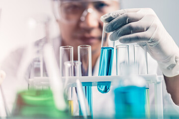 Biochemical research scientist working with science laboratory test tubes for coronavirus vaccine...