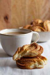 close-up of sweet pastries with a cup of coffee on the table on a wooden background