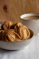 close-up of sweet pastries with a cup of coffee on the table on a wooden background