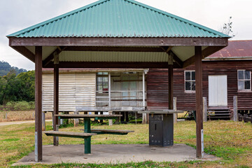 A Covered Picnic Area Beside An Abandoned Community Hall