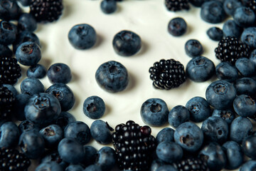 Close-up blueberry and blackberry on sour cream