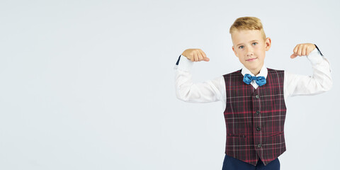 A portrait of a schoolboy who demonstrates his strength. Isolated background.