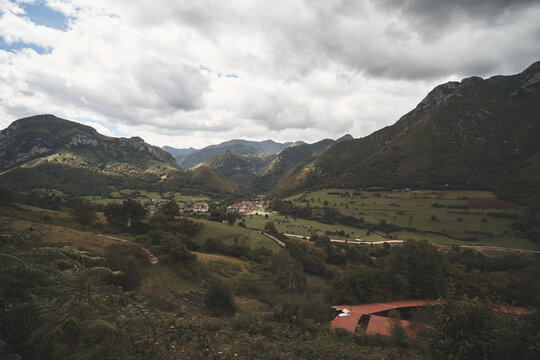 Aerial shot of a village at a valley on a cloudy day at Soto de Agues, Asturias, Spain