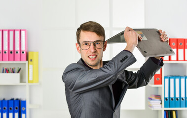 Mad man throwing away laptop online job, hateful job concept