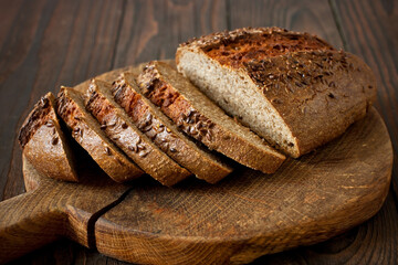 Homemade  wholegrain bread with seeds on wooden board