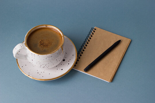 Cup of coffee and notebook. Minimalism style.