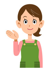 Obraz premium 手のひらで案内するエプロンをつけた女性の上半身 