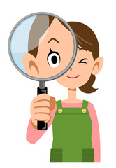 虫眼鏡を覗くエプロンをつけた女性の上半身
