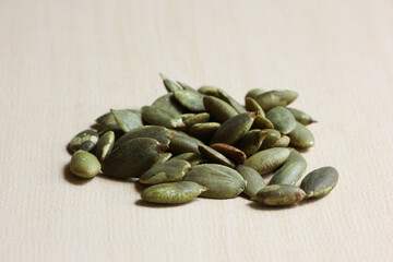 Pumpkin Seeds on Wood Background.