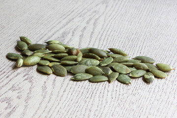 Pumpkin Seeds on Wood Background.
