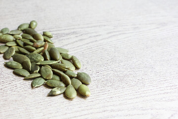 Pumpkin Seeds on Wood Background.
